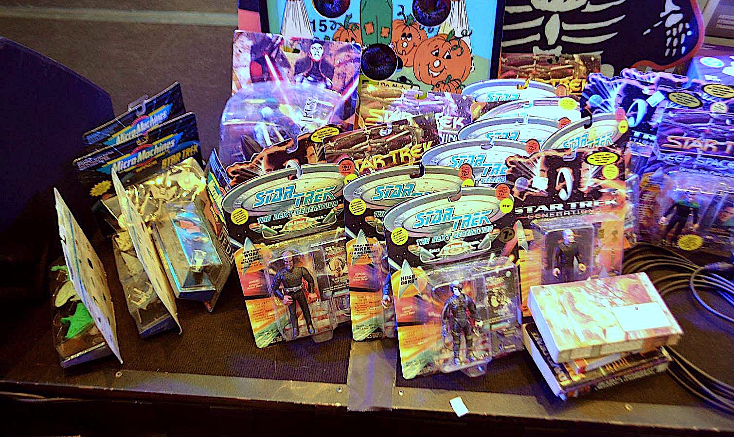 Picture of Star Trek action figures new in box, some books, and other items donated for the charity auction.